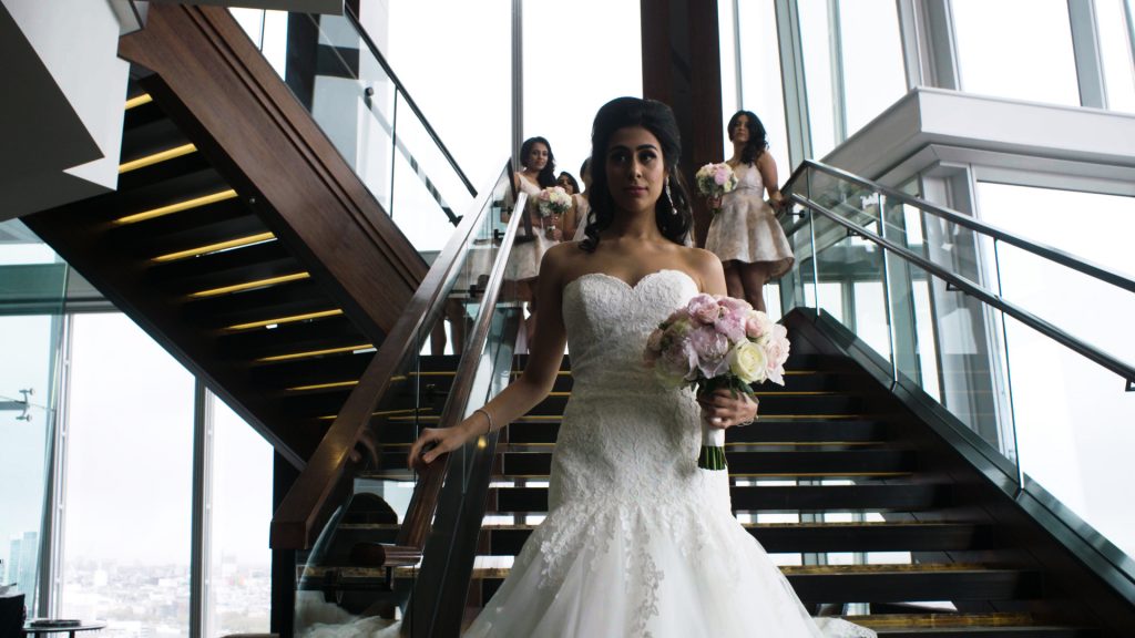 Luxury Wedding Film bride walks down the stairs